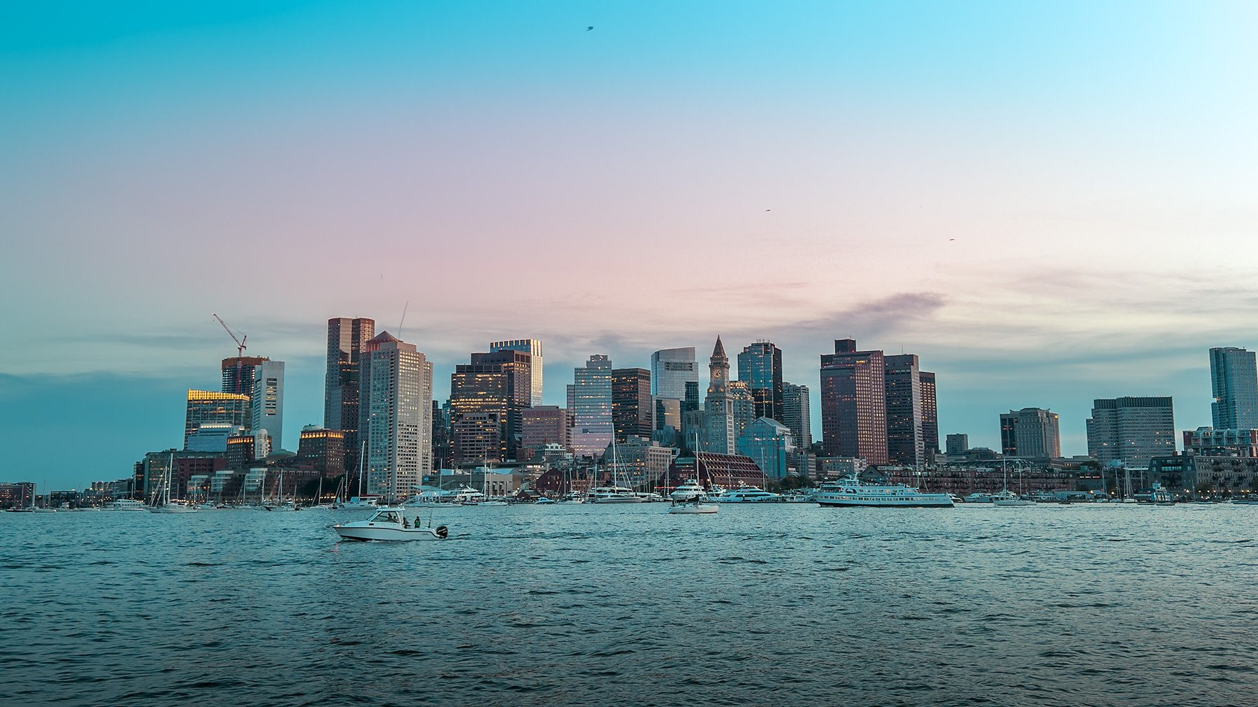 The Boston skyline from the water at dusk