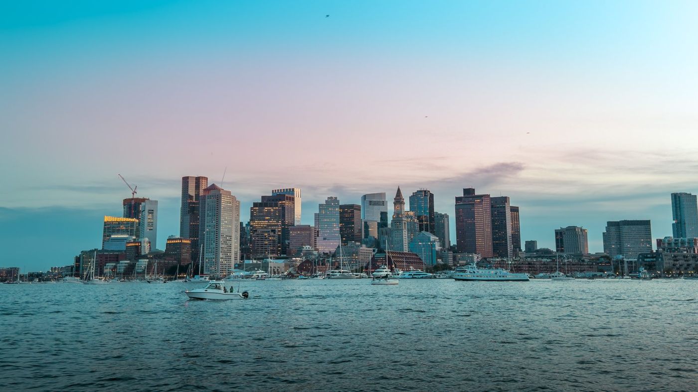 The Boston skyline across the harbor at dusk