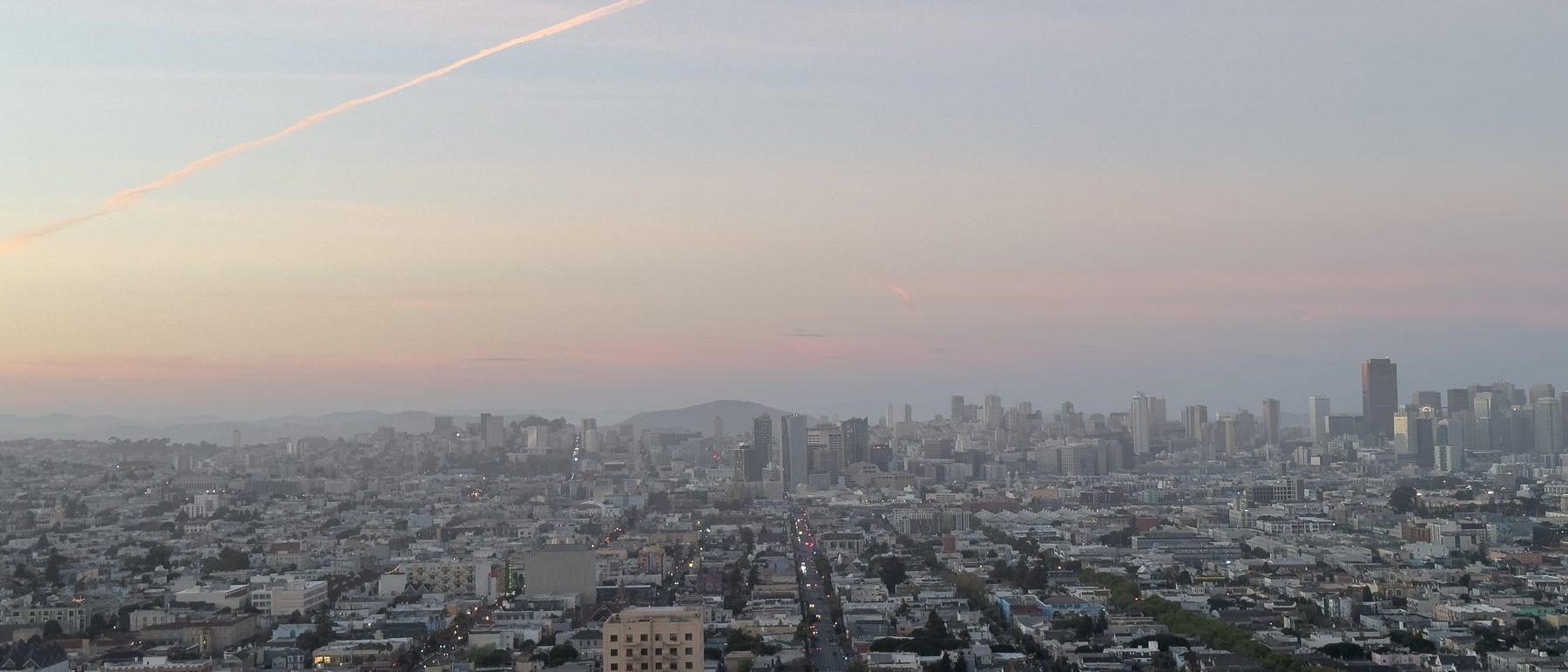 San Francisco seen from above on a hazy evening, the downtown towers in the distance