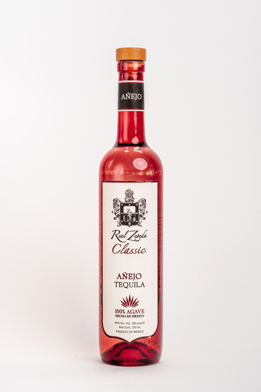 A bottle of Real Zepeda Classic Añejo tequila on a white background