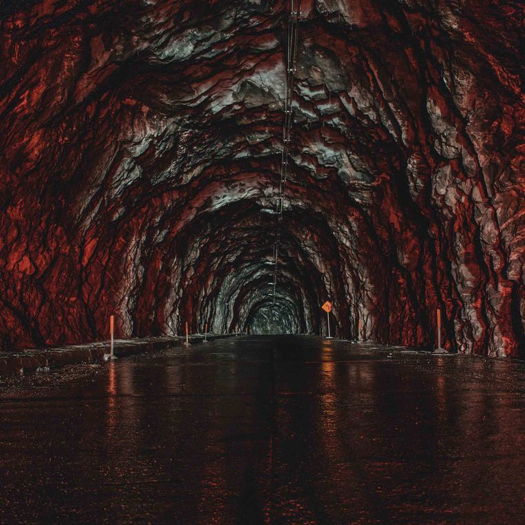 A tunnel cut through red rock